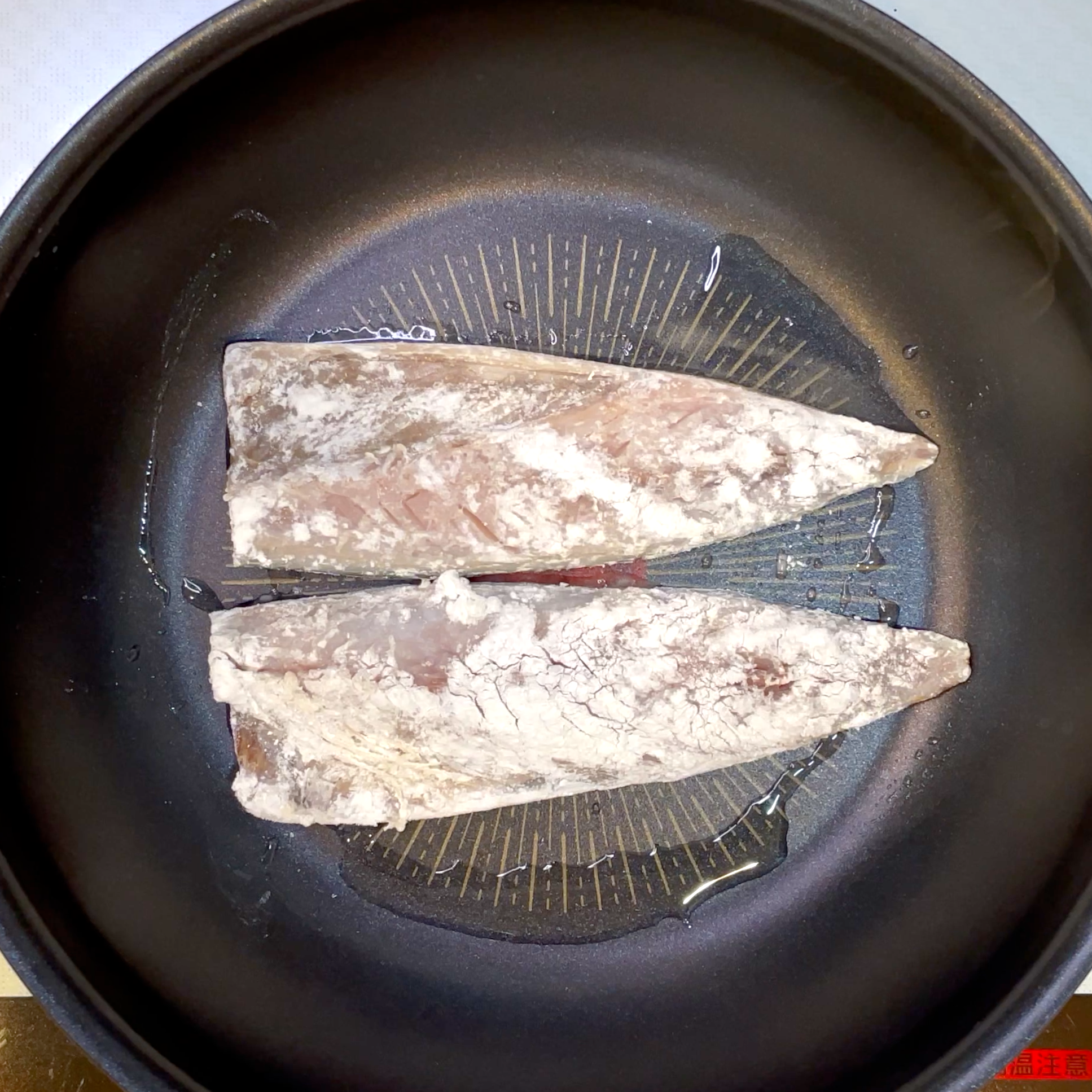 サラダ油をひいたフライパンでサバの皮目から焼く工程